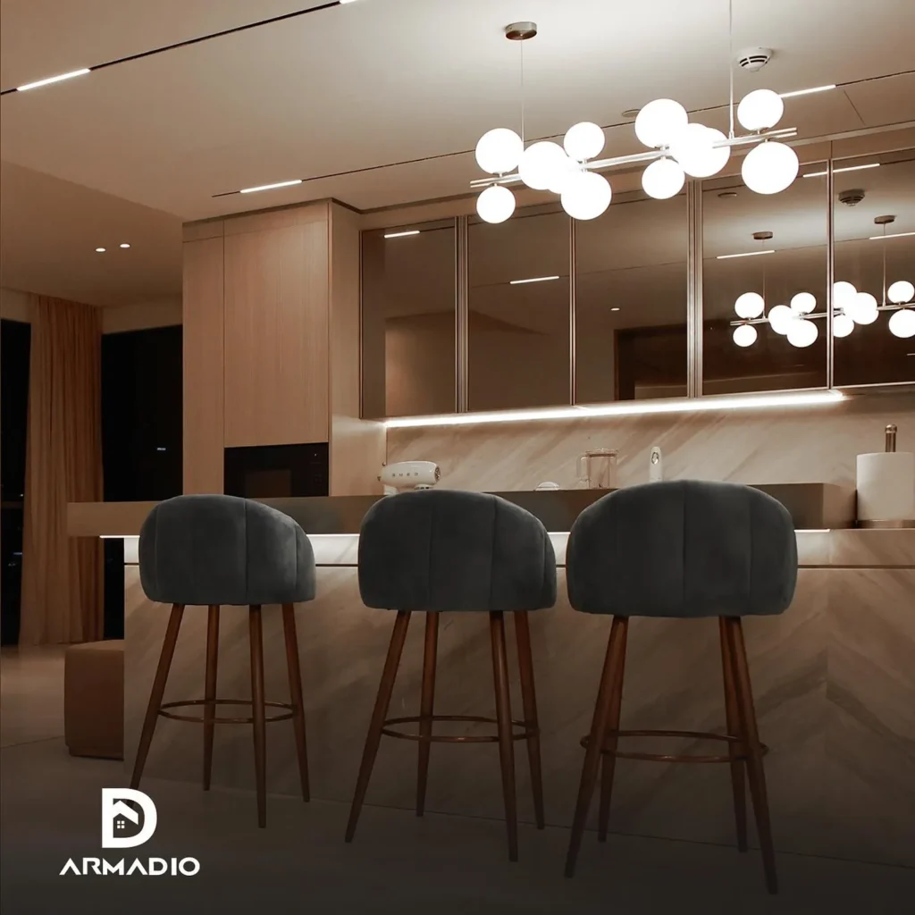 Minimalist kitchen with globe pendant lights, marble island, and velvet bar stools