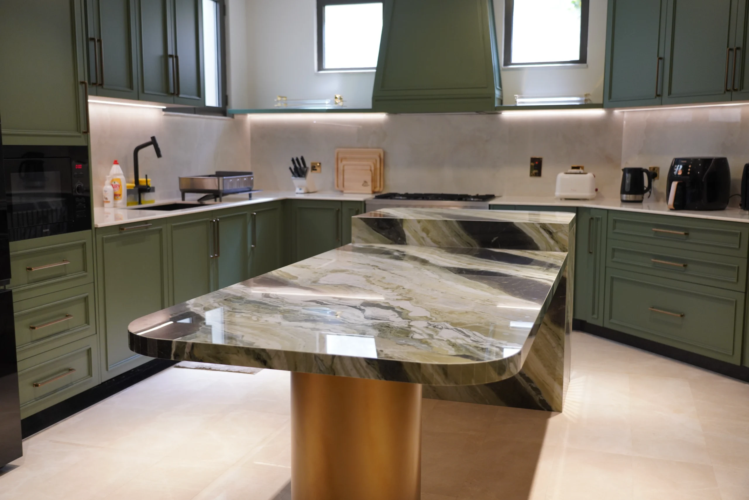 Custom green kitchen with marble island by Armadio